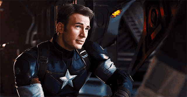 a close up of a man in a captain america uniform with a star on his chest .