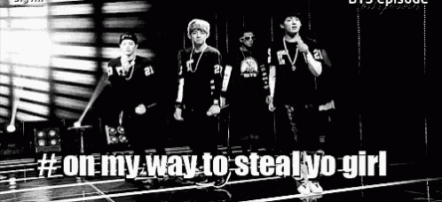 a black and white photo of a group of young men standing next to each other on a stage .