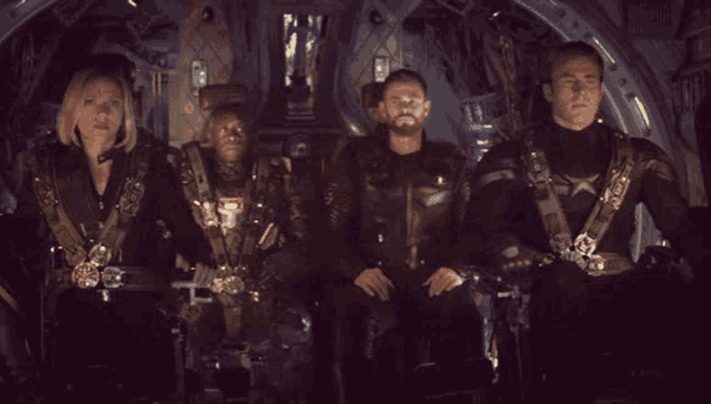 a group of people are sitting in a dark room