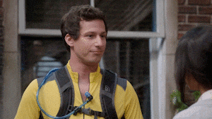 a man wearing a yellow shirt has a water bottle attached to his back