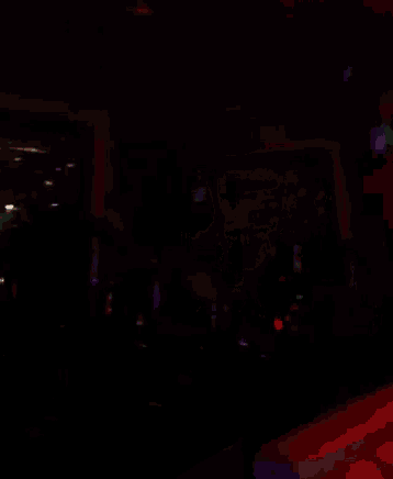 a dark room with a red light on in the corner