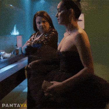 a woman in a black dress is standing next to another woman with pantaya written on the bottom of the image