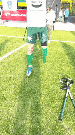 a person wearing green shorts that say harting on the back