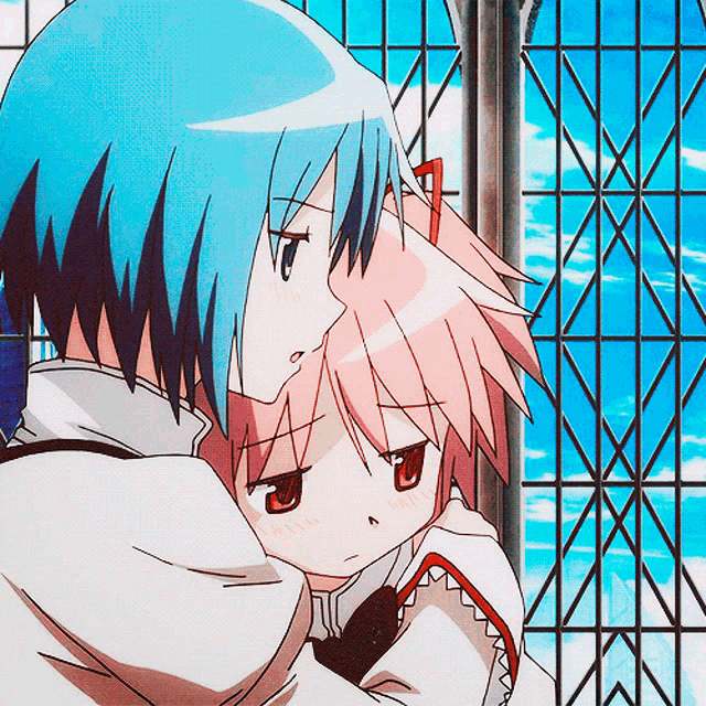 a boy and a girl are hugging each other in front of a window
