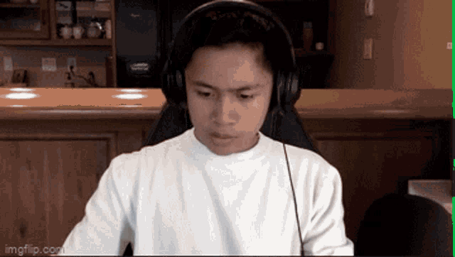 a man wearing headphones is sitting in front of a computer monitor