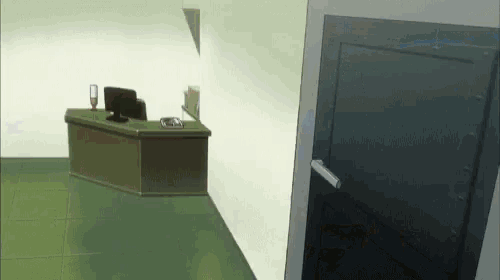 a corner of a room with a desk and a computer on it