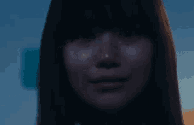 a woman is crying with tears coming out of her eyes .