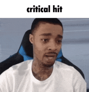 a man in a white shirt is sitting in a chair with the words " critical hit " above him