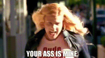 a woman is running down a street with the words `` your ass is mine '' .