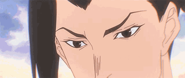 a close up of a person 's face with a serious look on their face .