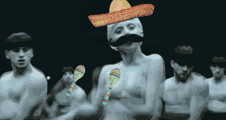 a man with a sombrero on his head and a mustache is surrounded by men