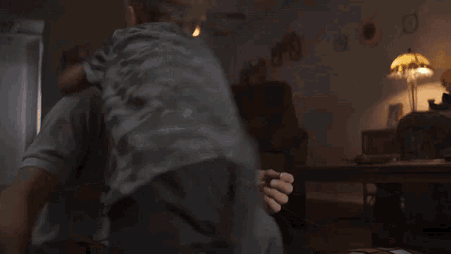 a man is hugging a child in a dark room
