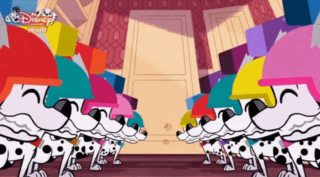 a group of dalmatian dogs wearing colorful hats are standing next to each other