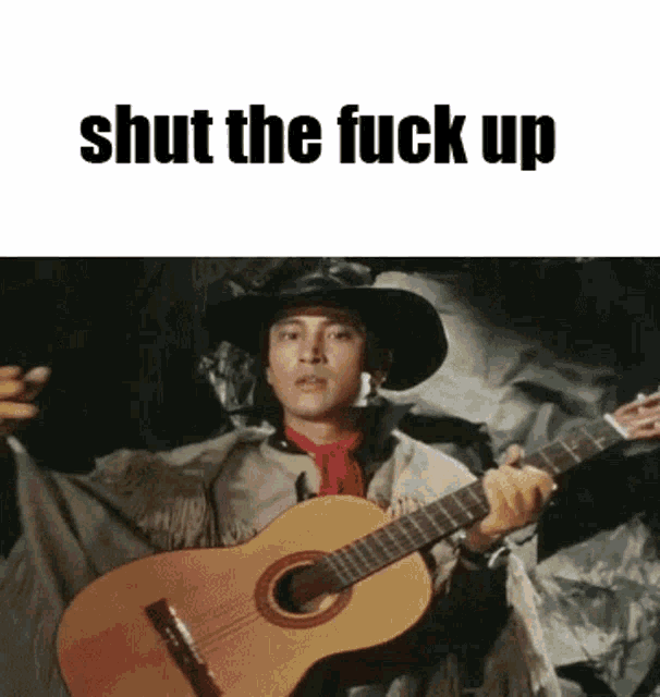 a man in a cowboy hat is holding a guitar with the words shut the fuck up above him .
