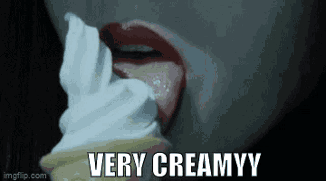 a woman is licking an ice cream cone with the words very creamyy above her mouth
