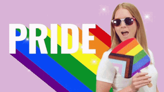 a woman wearing sunglasses is holding a rainbow flag in front of a pink background that says pride