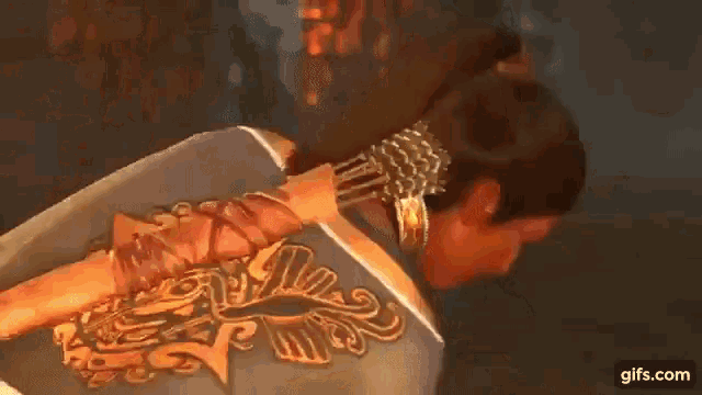 a woman is holding a sword on her back in a video game while standing in a dark room .