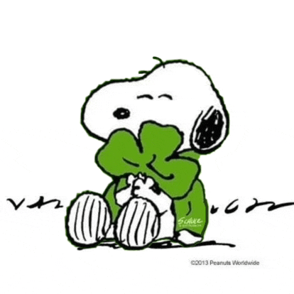 a cartoon of snoopy wearing a green bow tie and a green sweater .