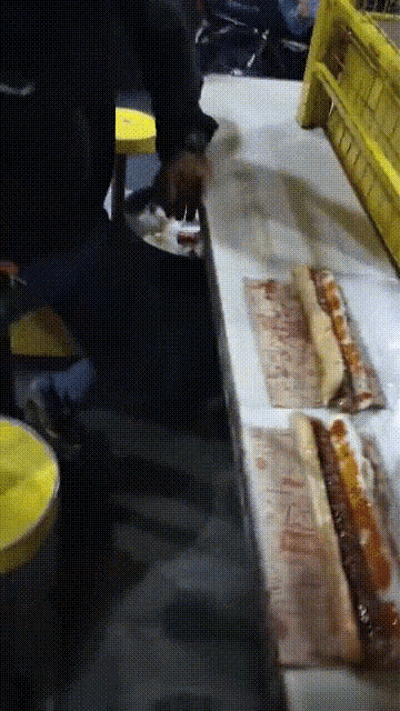 a bunch of sandwiches are sitting on a counter and one of them has a label that says ' beef ' on it