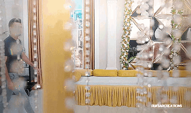 a reflection of a man in a mirror with ruksarcreations written on the bottom right