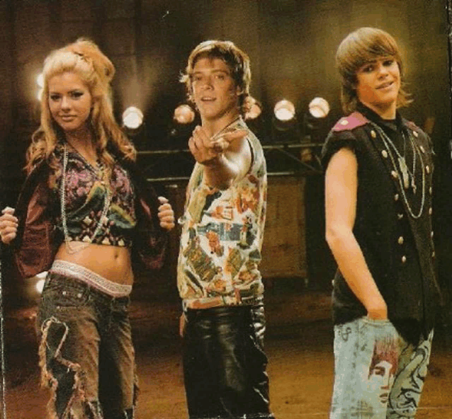 a group of young people standing next to each other one of whom is wearing a black vest with the letter e on it