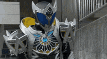 a person in a superhero costume is standing next to a wall .