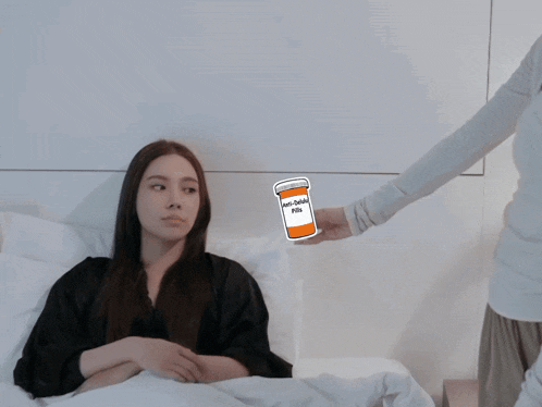 a woman laying in bed with a sticker of a bottle of anti-depressant pills