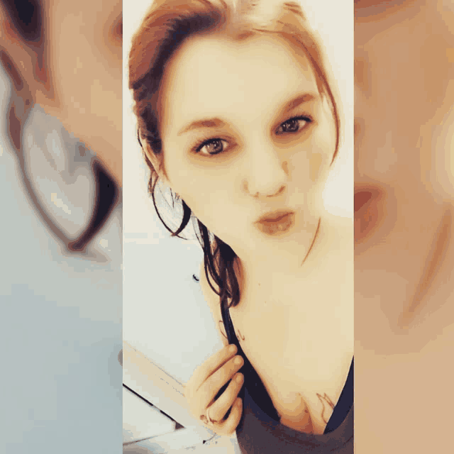 a woman with a tattoo on her chest is blowing a kiss at the camera