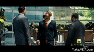 a woman in a suit talks to a man in a suit in a lobby with the words blacktree.com on the bottom left