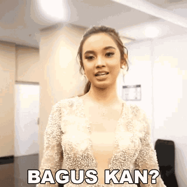 a woman in a pearl dress is standing in a room and says bagus kan ?