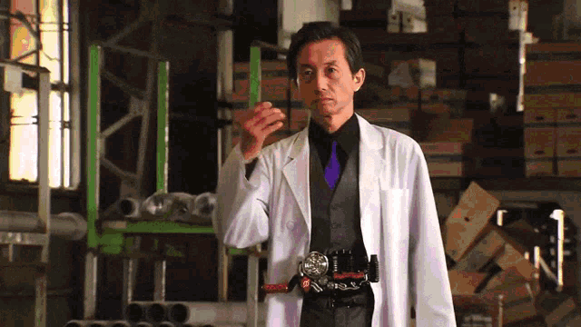 a man wearing a white coat and a purple tie is standing in a warehouse