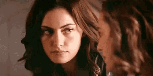a close up of two women looking at each other with their eyes closed .