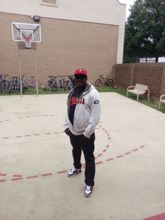 a man standing in front of a basketball hoop wearing a jacket that says georgia