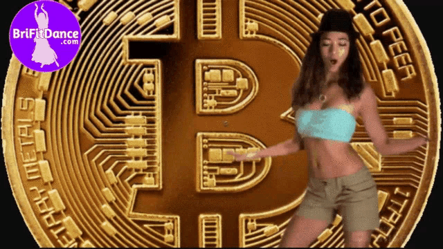 a woman is dancing in front of a large bitcoin