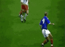 a soccer player with the number 10 on his jersey is trying to get the ball