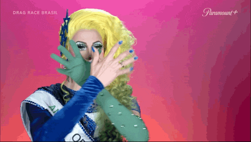 a drag queen from drag race brasil is covering her face