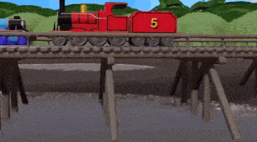 a blue train and a red train are crossing a bridge .