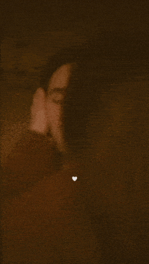 a woman kissing a man on the cheek with a heart on her chest