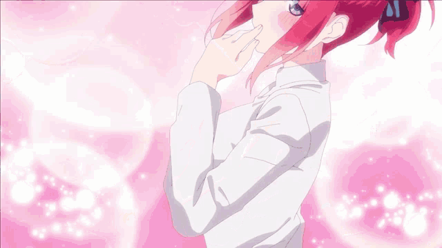 a girl with red hair and blue eyes is blowing a heart out of her hand