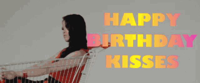 a woman sits in a shopping cart with the words happy birthday kisses
