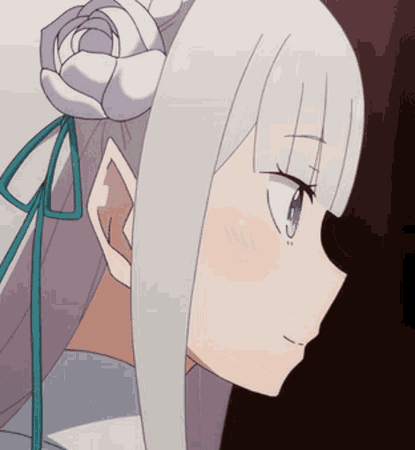 a close up of a girl 's face with white hair and a flower in her hair