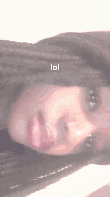 a close up of a woman 's face with the word lol on the bottom right corner .