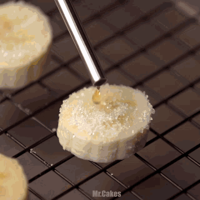 a slice of banana is being drizzled with syrup and sugar