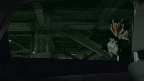 a blurred image of a person 's face behind a broken glass
