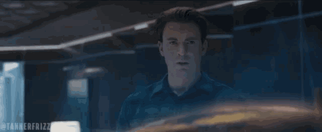 a man in a blue shirt with the words let 's go get this son of a bitch