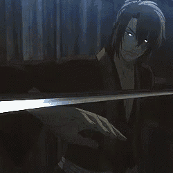 a man is holding a sword in a dark room .