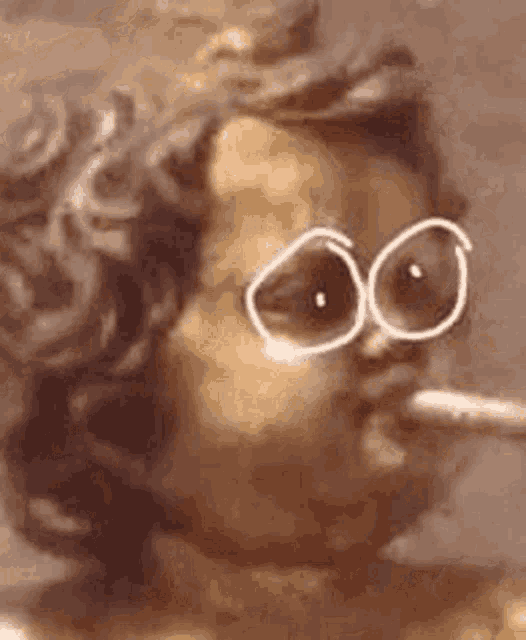 a close up of a statue of an angel smoking a cigarette .