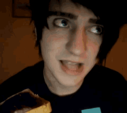 a close up of a person holding a banana in their hand .