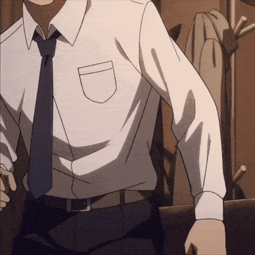 a man in a white shirt and tie is standing