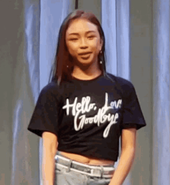 a woman is wearing a black t-shirt that says hello love goodbye